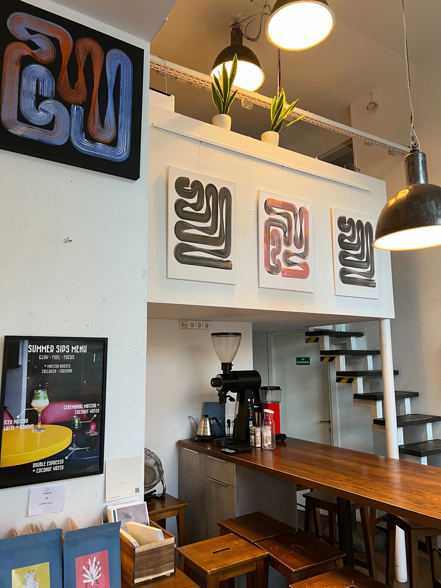 Lineage Noir and Lineage Blanc paintings installed at Elska Coffee in Vilnius