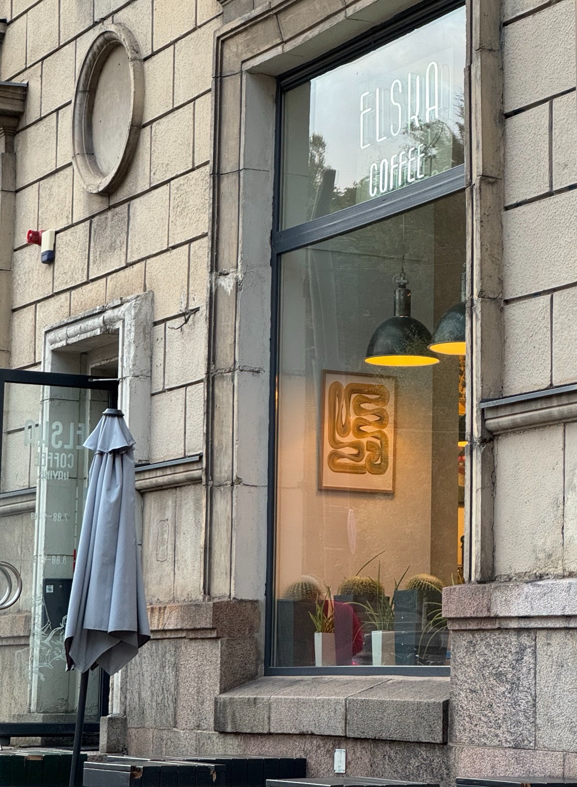 Lineage painting seen through the window of Elska Coffee in Vilnius