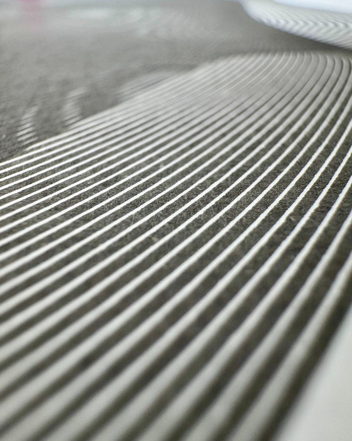 Close-up of white linework on dark paper surface